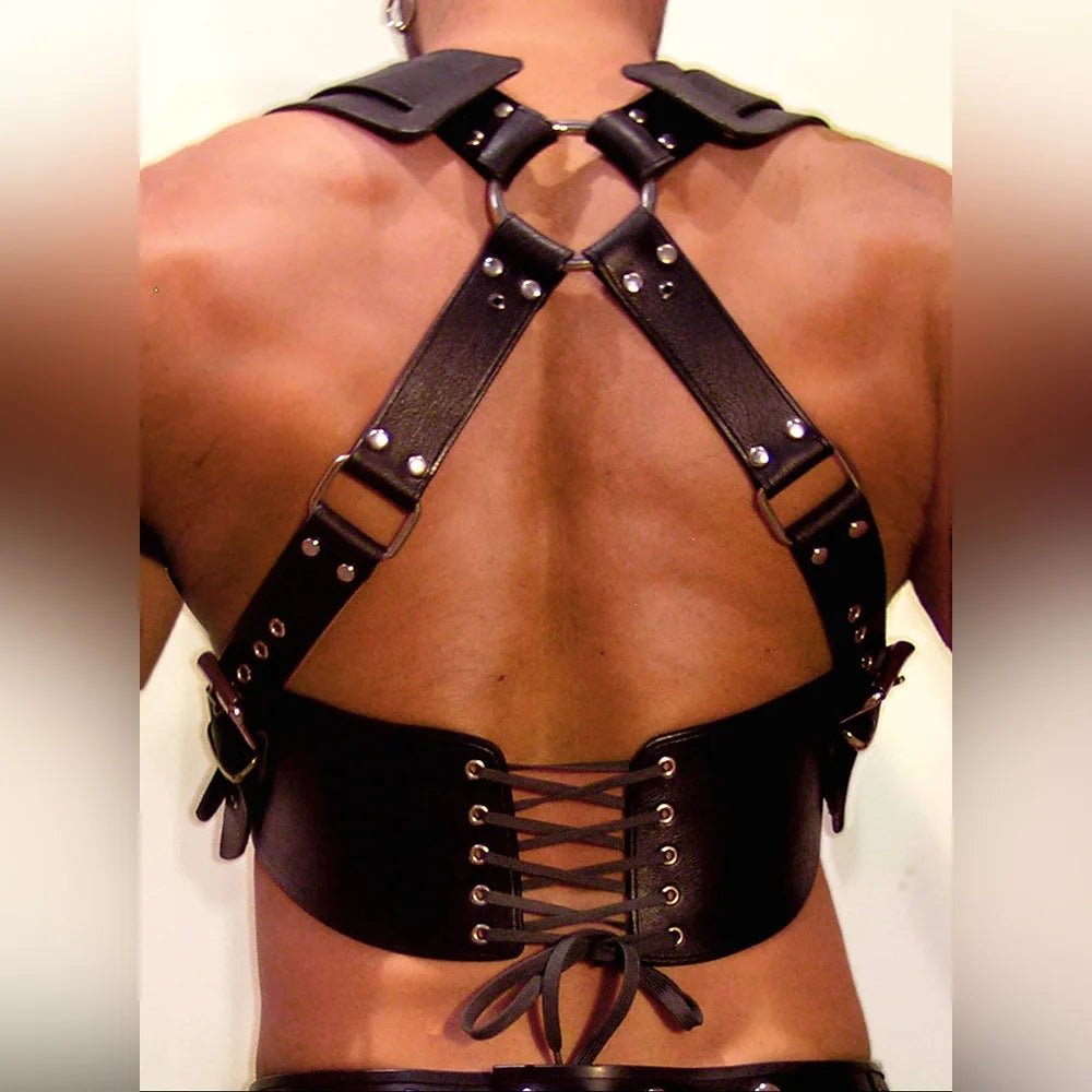 Close-up of material texture and finish on sexy men faux leather chest harness with buckles and armors